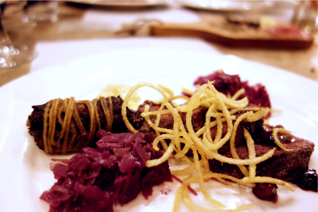 Kangaroo meat and red cabbage on a white plate