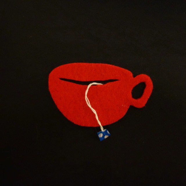 26: Red felt cutout of a teacup with string and washi tape tea tag
