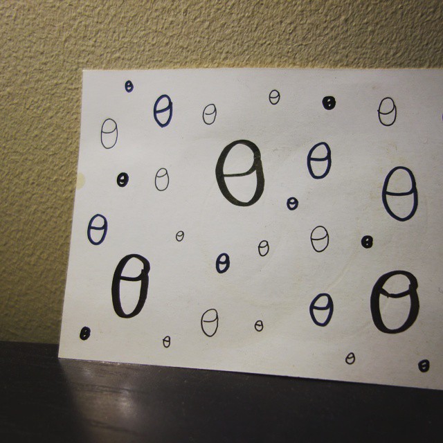 44: Theta symbols resembling simple teacups drawn in various sizes on a white card