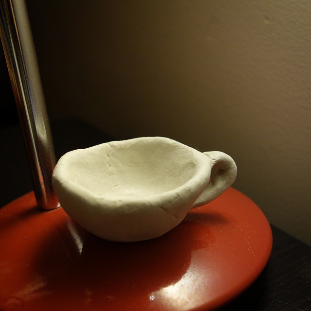 50: Small three-dimensional sculpture of a teacup made from white air-dry clay
