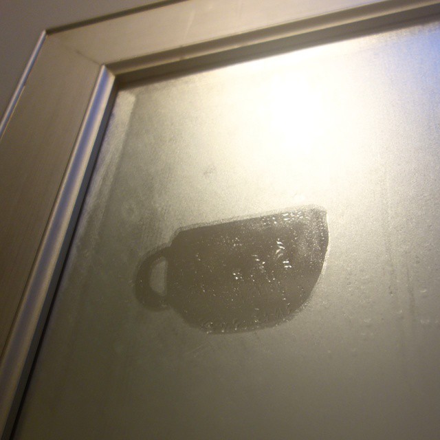 55: Finger-drawn teacup on foggy mirror
