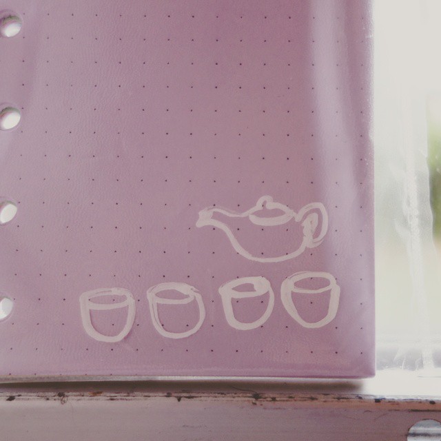 75: A set of four teacups and a teapot drawn in white-out on a clear plastic slip