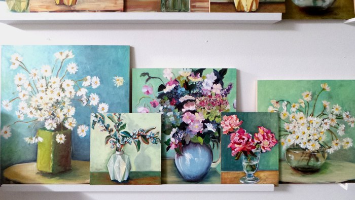 so many paintings of flowers in vases