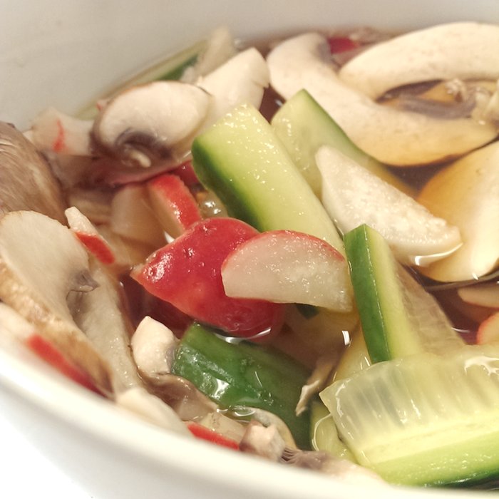 colourful pickles in a bowl of seasoning and vinegar