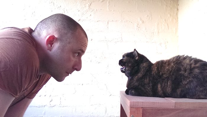 man and cat, having a conversation, c. 2014