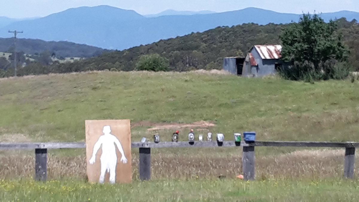 rifle targets set up along a fence