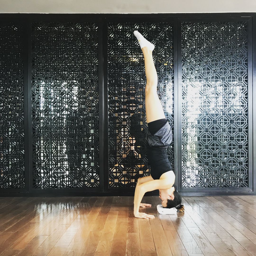 Doing a headstand in a fitness studio.